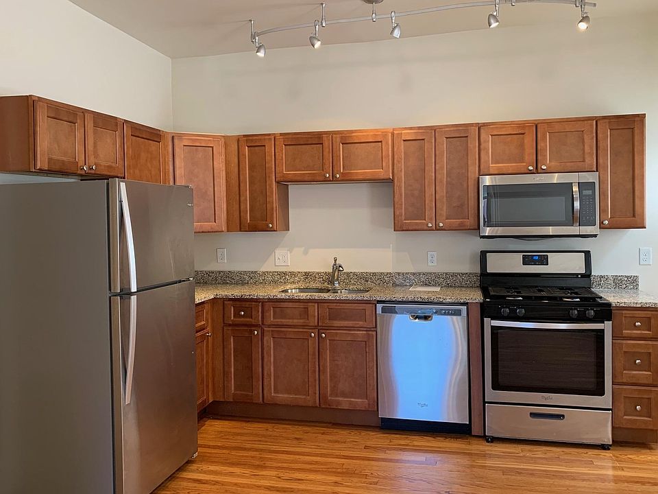 Kitchen - granite countertops, stainless steel appliances, wooden cabinets