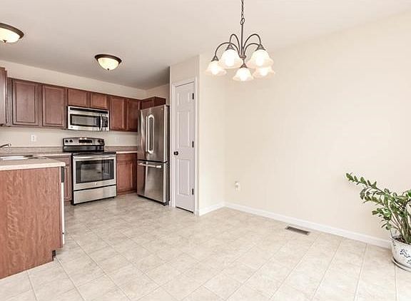 Upgraded kitchen cabinets,  pantry, and all stainless appliances including refrigerator with french doors.