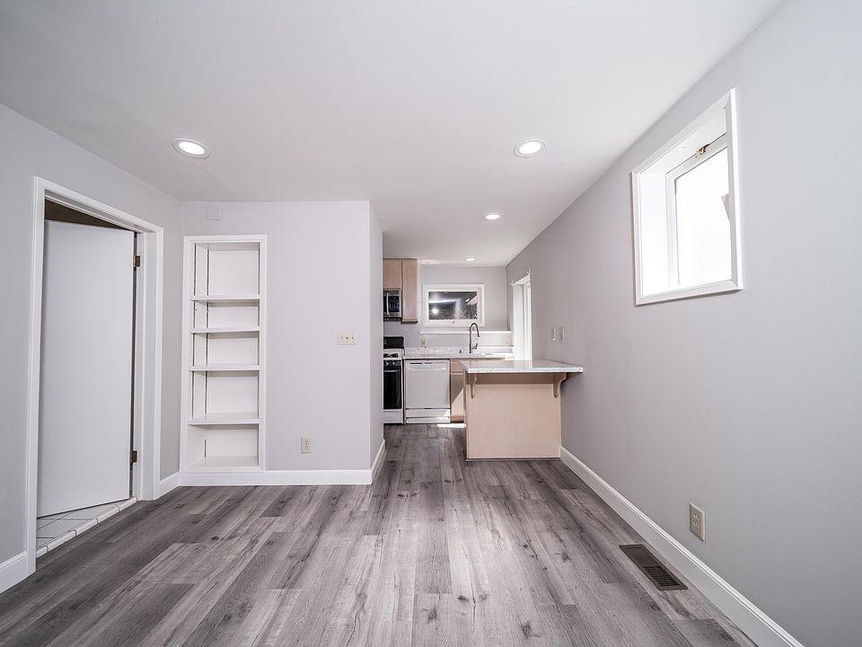 Living space to kitchen; bathroom at left