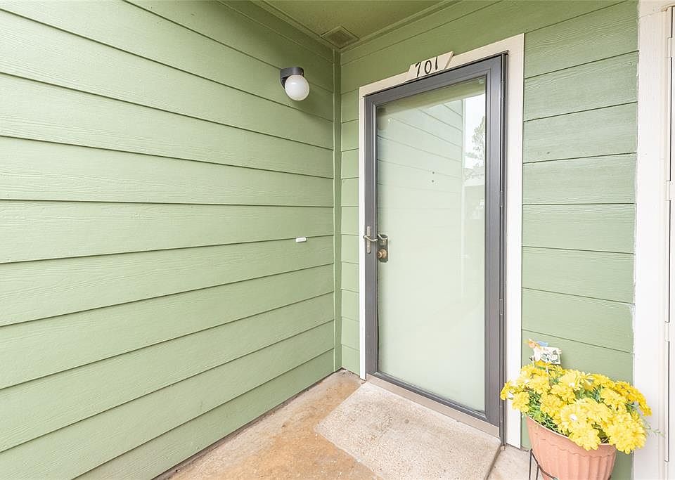 Welcome to 14777 Wunderlich Drive, Unit 701. Storm door adds a nice welcoming touch.
