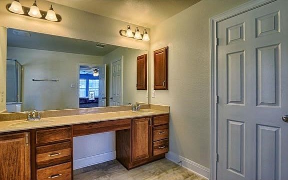Master bath offering double sinks.. vanity area. Lots of lighting and a medicine cabinet.