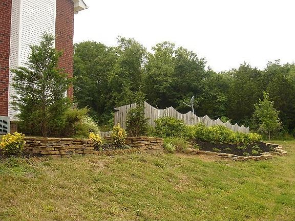Mature landscaping surrounds the home.