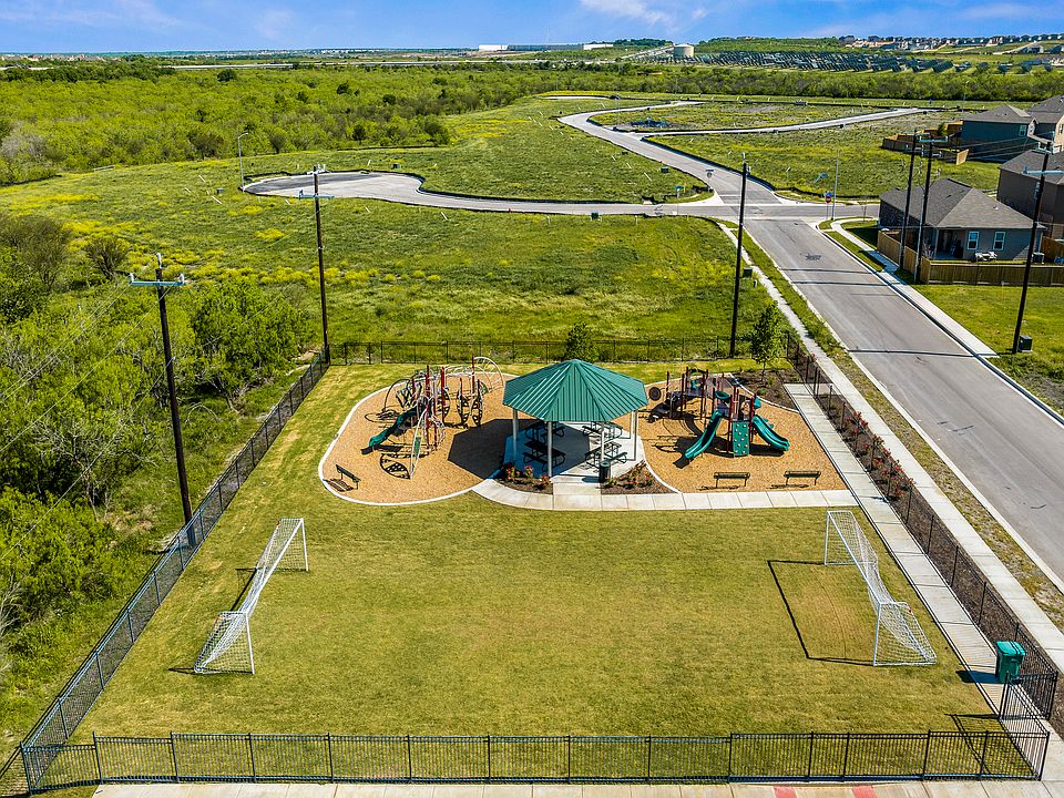 Community park with soccer field and playgrounds.