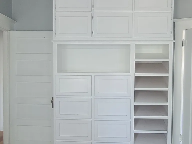 Custom built-in cabinets with wonderful storage options in this century home. This room can be a great large bedroom or a wonderful office or guest bedroom on the main floor.