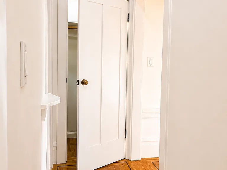Entry hallway with hardwood floors and period detailing