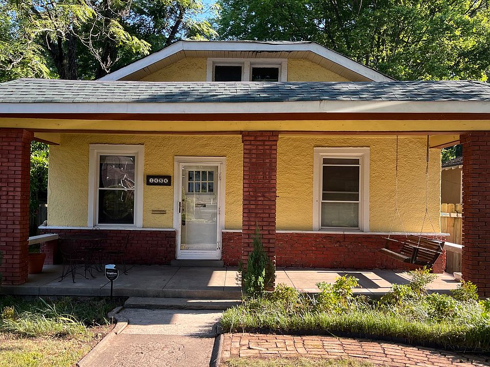Craftsman style stucco and brick house with open porch in Midtown Memphis.