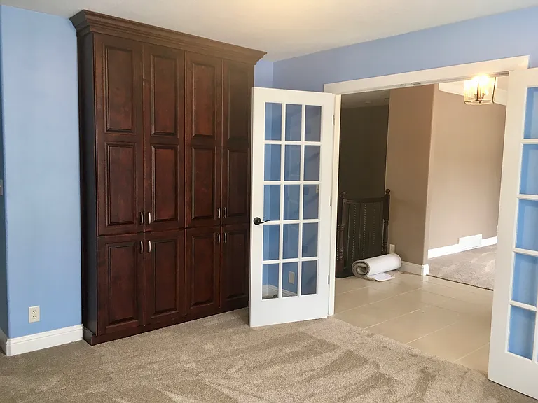 Third bedroom / den with French doors entry and brand new carpet.