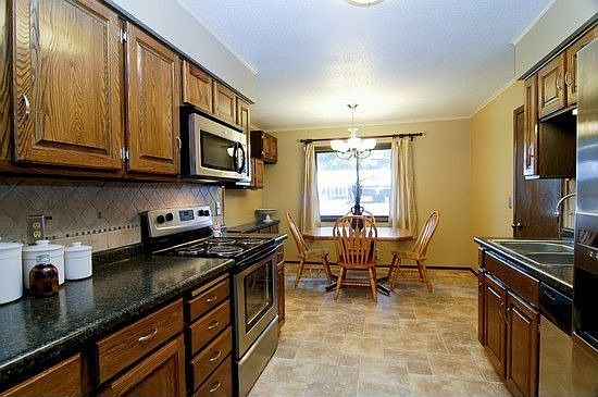 Kitchen remodel with new stainless steel appliances, countertops and floor
