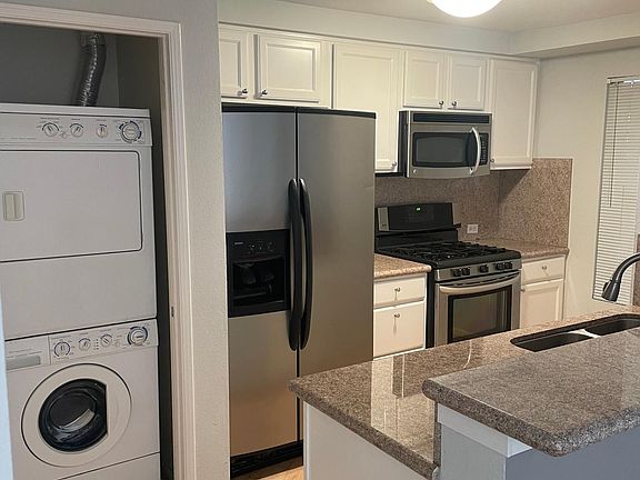 View of kitchen + washer/dryer