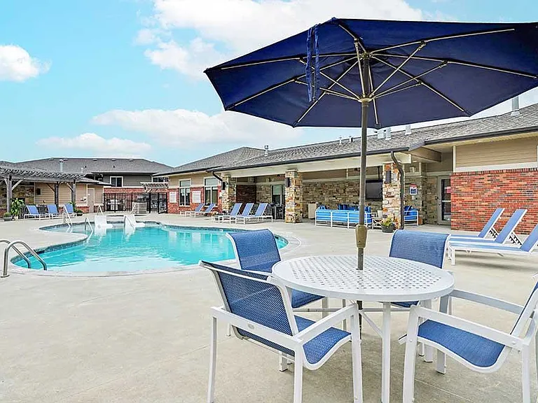 Relaxed afternoons unfold poolside with shaded seating and open-air spaces made for gathering, unwinding, and enjoying the sunshine.
