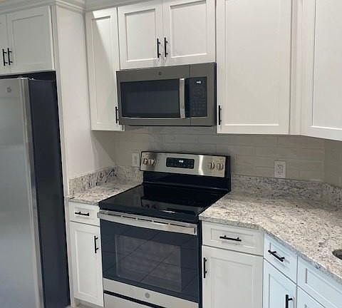Range, refrigerator, dishwasher and microwave brand new, never been used