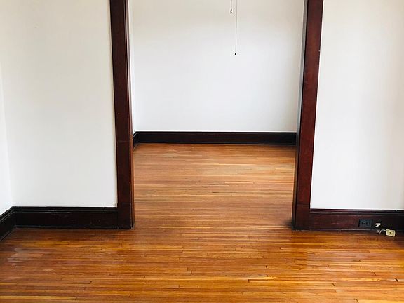 view from living room to sitting room, large closet in sitting room.