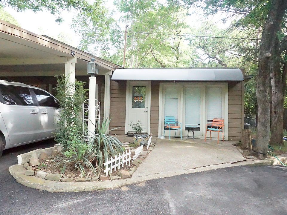 Front view. Private front patio, personal garden, side yard, and dog run. Covered parking , RV parking, boat parking, golf cart parking all available. Designated spot just steps from covered front door.