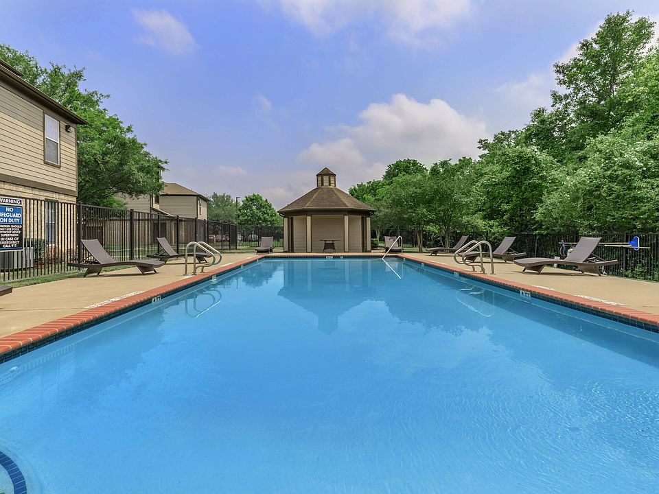 Resort-Style Swimming Pool with Lounge Seating at Houston Apartment Community. Lease your new home at North Forest Trails today!