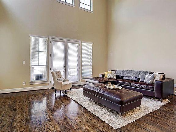 Another view of the living room - you can see the double French doors leading to the balcony and the windows above that allow for light to enter. From this angle, you have a better sense of jut how spacious this room is.