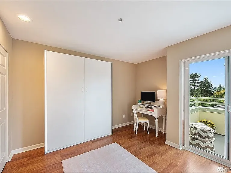 (Staged) Second bedroom with queen sized Murphy Bed and patio access