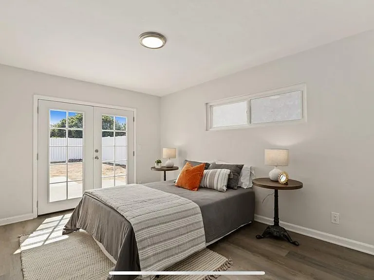 Bedroom with French doors leading to back patio and backyard