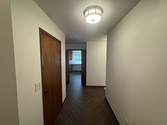 Entry view, kitchen straight ahead, hallway to master suite on right.