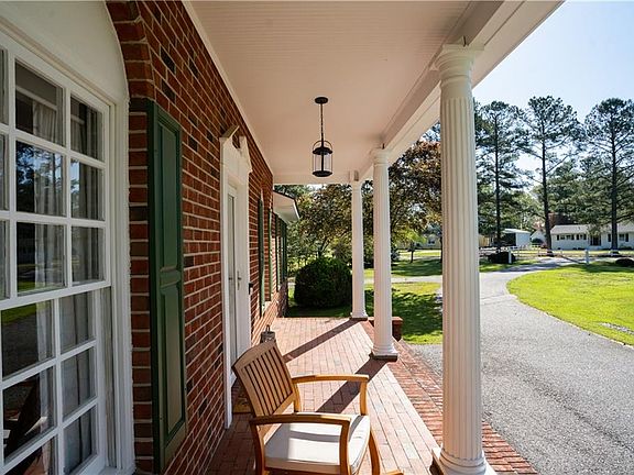 Gorgeous front porch with columns, and a circular driveway