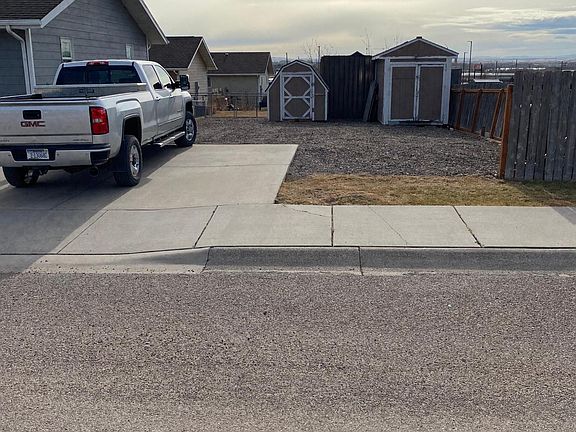 Off-street parking with two storage sheds