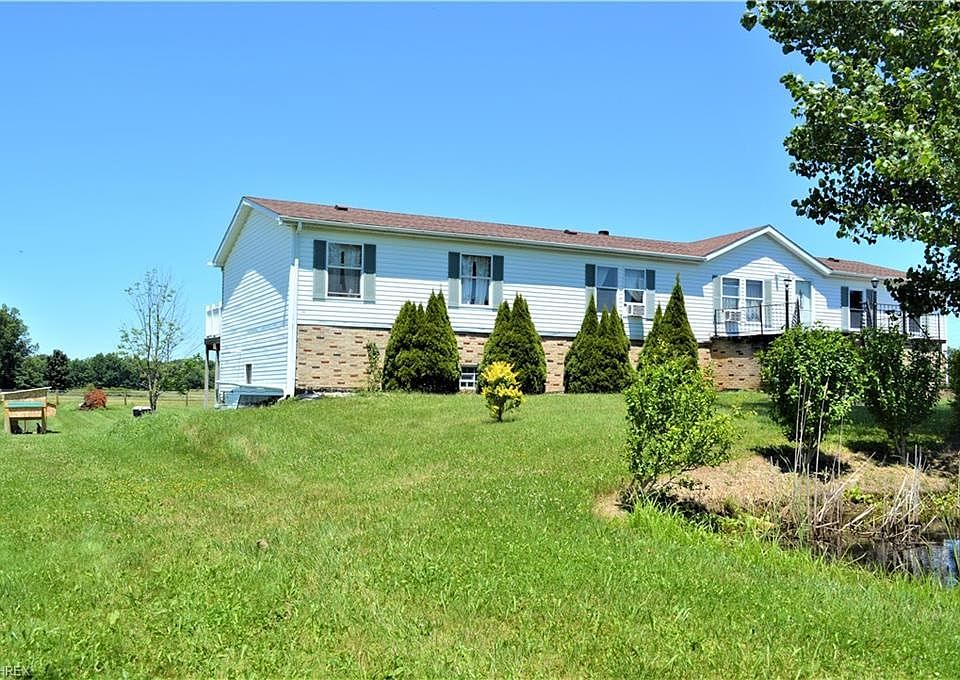 Country Living = 15184 West Akron Canfield Rd. 6.5 acres of woods, pond, creek & paddocks.