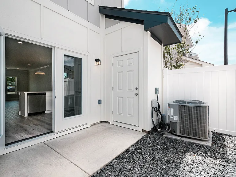 Beautiful private patio. Where you see gravel is being changed to pavers to give you a large area for grilling and an outdoor table. Six-foot privacy fence with gate to the back parking lot.