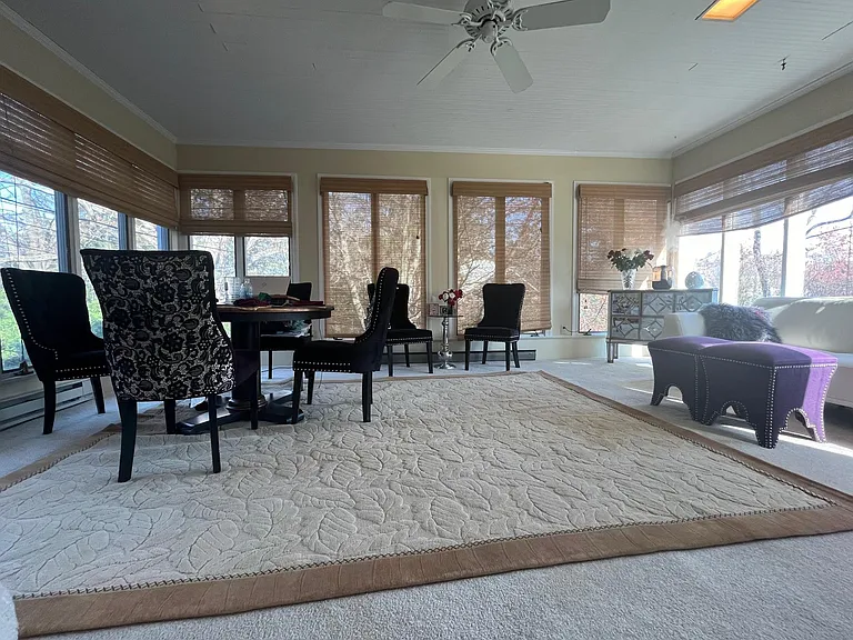 Sun, sun, sunny sunroom - sun streams in from all four sides and offers an elevated view of the trees/lawn.