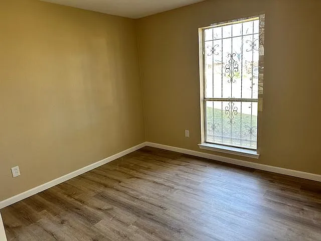 Bedroom features newly installed wood flooring and generous closet space.