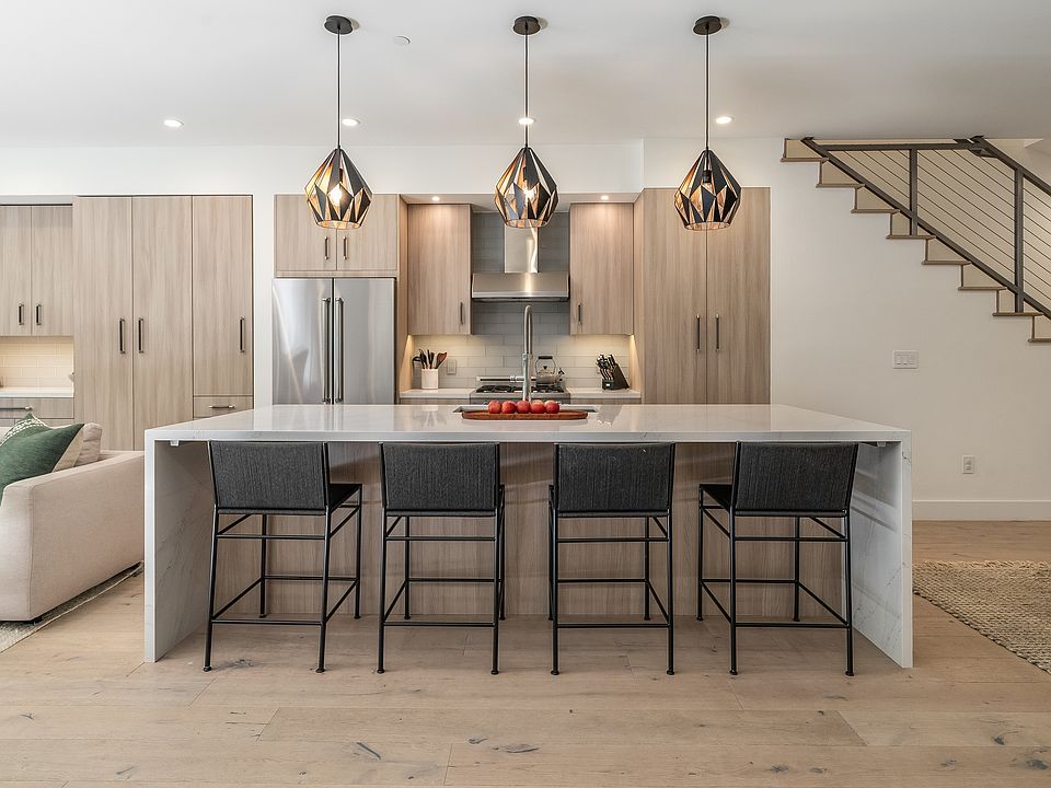Kitchen breakfast bar with pantry on the right and extensive storage on the left.