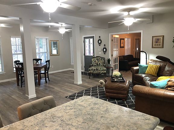 Photo taken from the bar area overlooking family room and looking towards the larger bedroom and main entry door.