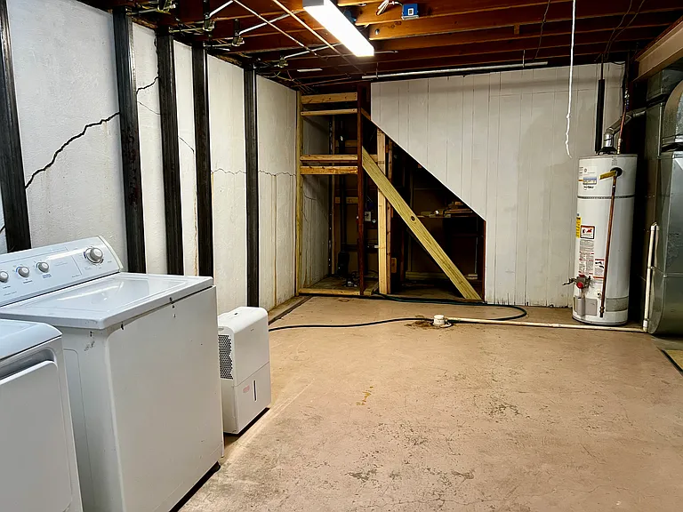 Basement unfinished area. Please be advised that the basement leaks during heavy rain. Sump pump installed, which turns on and off automatically.