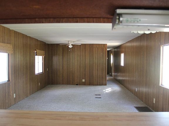 Looking into living room from kitchen. Hall leads to bathro