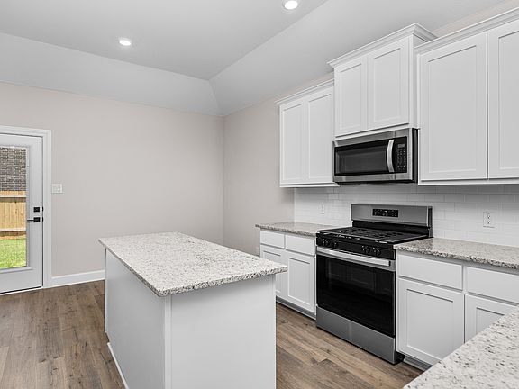 The kitchen has sprawling granite countertops.