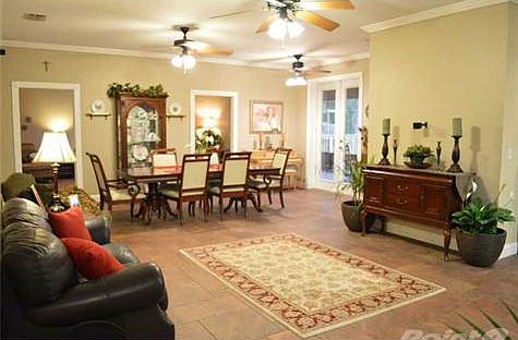 The floor plan is thoroughly modern. The gathering room and formal dining room open up to the family