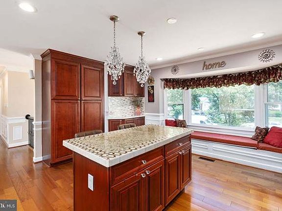 (Kitchen) Kitchen island and bay window seating/storage space.