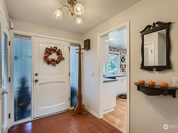 Front door opens to a generous dedicated entryway with full coat closet.>