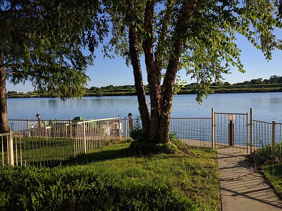 Fenced lakeside backyard