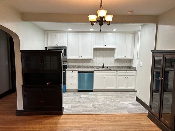 New tile and kitchen. Adjacent to the kitchen is bathroom