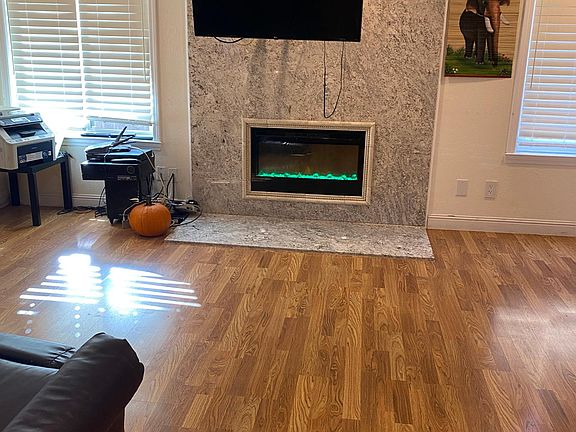 Family room with electric fireplace with changing color flames. Extra safe for small children.