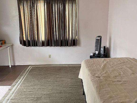 Window carpeted floor and included single bed.