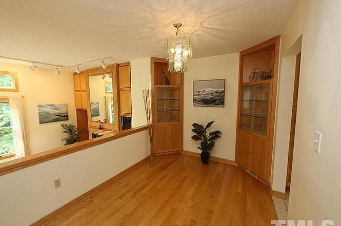 The dining room overlooks the sunken living room and the kitchen is through the door to the right