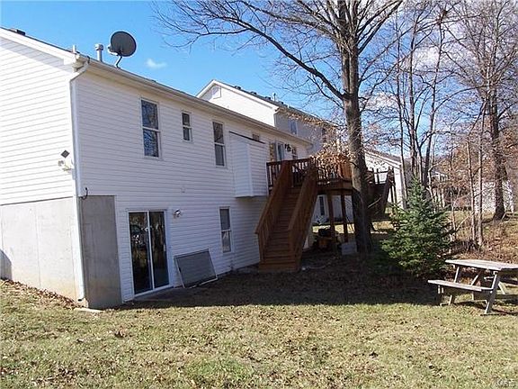 Large deck overlooks treed, private rear yard.