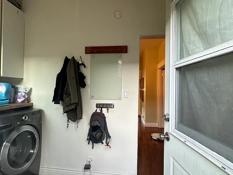 Backdoor leading to laundry room than kitchen