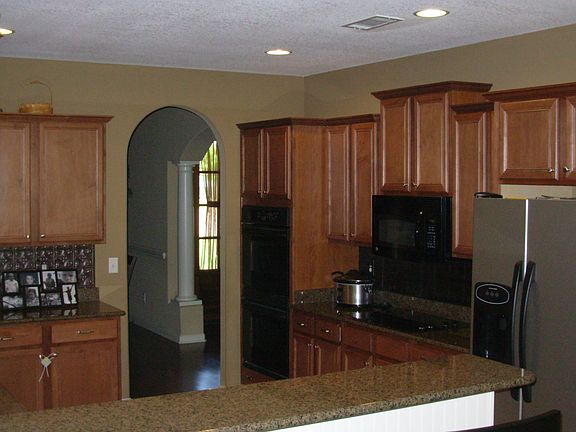 Tons of cabinets, double ovens, and flat top stove