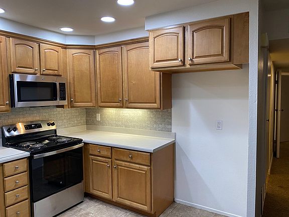 tile kitchen with lighted solid countertops brand new stainless appliances