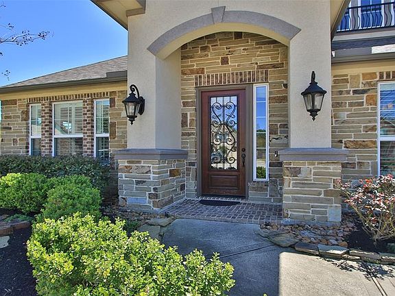 The stone, brick and stucco exterior add a special flair to this attractive home in Northwest Houston.