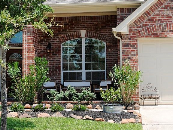 ENJOY A VIEW OF THE CUL-DE-SAC FROM YOUR COVERED FRONT PORCH