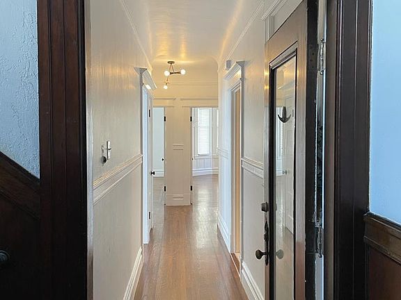 Hallway in Unit to Bedroom (left), Bathroom (left), Living room (straight to the left), 2nd Bedroom (straight to the right), Kitchen (right)