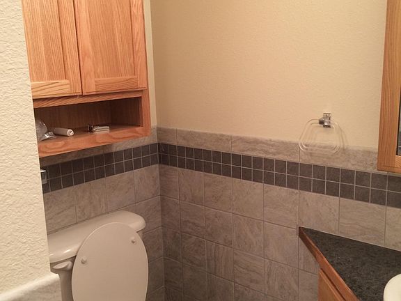 Deluxe bathroom with accent wall tile and flooring