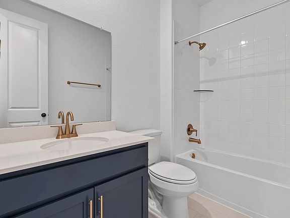 Stylish third bathroom showcasing the AW Collection Sapphire with blue cabinets, gold hardware, and